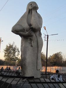 1985 sculpture by Holocaust survivor Ruth Waterman stands across the street from the walled-in factory site.  Gretchen Jennings. January 2014.