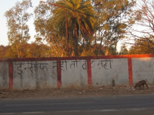 Grafitti on the factory wall calling for justice for victims.